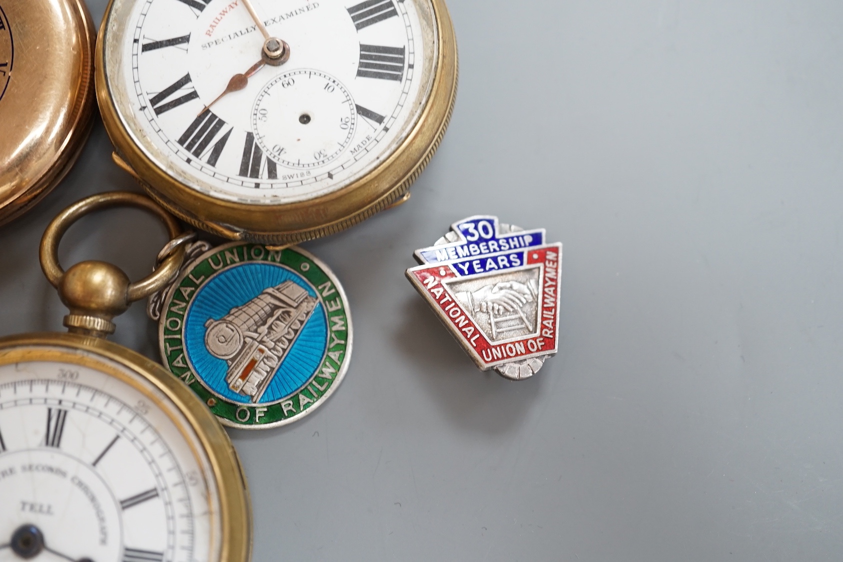 Two base metal Railway Timekeeper pocket watches, one other base metal pocket watch, a gold plated pocket watch and a railway badge and medallion.